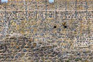 Picture of old stone wall in Muenzenberg castle ruins in contrast with blue sky photo