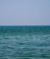 Vertical front view landscape Blue sea and sky blue background morning day look calm summer Nature tropical sea Beautiful  ocen water travel Bangsaen Beach East thailand Chonburi Exotic horizon. photo