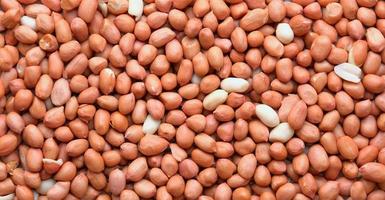 Top view of Raw Peanuts background. Pile of raw peanuts beans texture. photo