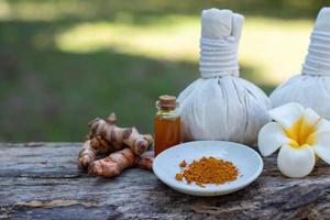 herbal compress ball with Thai herbal, turmeric, essential oil and bar soap. Spa background concept.. photo
