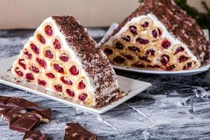 A traditional Moldavian dessert or cake consisting of pancakes with cherry, milk creme and chocolate creme also called Cosma lui Guguta. photo