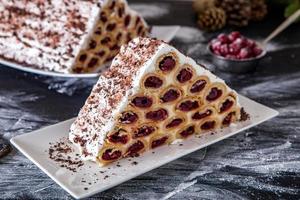 A traditional Moldavian dessert or cake consisting of pancakes with cherry, milk creme and chocolate creme also called Cosma lui Guguta. photo