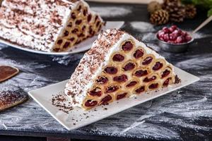 A traditional Moldavian dessert or cake consisting of pancakes with cherry, milk creme and chocolate creme also called Cosma lui Guguta. photo