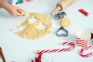 Family cooking homemade cakes. Moms and children hands holding cookie cutters. Family Cooking flat lay. Sweet home. Happiness concept. photo