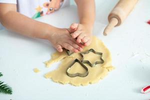 Family cooking homemade cakes. Moms and children hands holding cookie cutters. Family Cooking flat lay. Sweet home. Happiness concept. photo