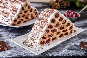 A traditional Moldavian dessert or cake consisting of pancakes with cherry, milk creme and chocolate creme also called Cosma lui Guguta. photo