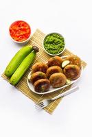 Raw Banana Cutlet also called plantain or kacche kele ki tikki or patties, served with chutney photo