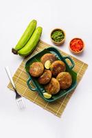 Raw Banana Cutlet also called plantain or kacche kele ki tikki or patties, served with chutney photo