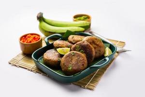 Raw Banana Cutlet also called plantain or kacche kele ki tikki or patties, served with chutney photo