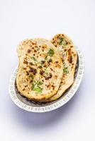 tandoori naan, tandoori roti indio o pan plano servido en un plato, aislado foto