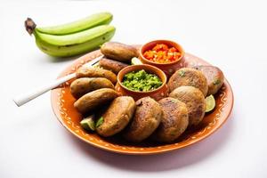 Raw Banana Cutlet also called plantain or kacche kele ki tikki or patties, served with chutney photo