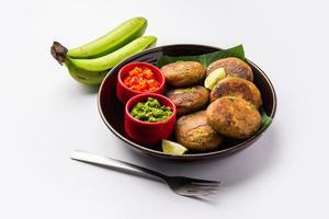 Raw Banana Cutlet also called plantain or kacche kele ki tikki or patties, served with chutney photo