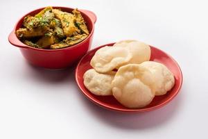 Aloo Patol sabzi made using pointed gourd and potato served with fried Luchi or poori, Bengali food photo