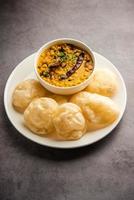 Luchi Cholar Dal or Fried bread made of flour served along with curried Chana or Bengal gram photo