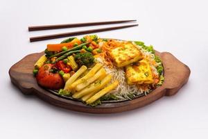 Paneer Sizzler is an Indian version with cottage cheese, salad served sizzling on hot stone dish. photo