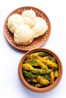 Aloo Patol sabzi made using pointed gourd and potato served with fried Luchi or poori, Bengali food photo