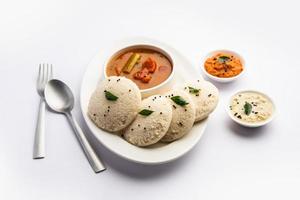 Idly sambar or Idli with Sambhar and green, red chutney. Popular South indian breakfast photo