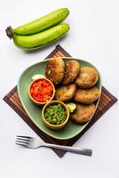 Raw Banana Cutlet also called plantain or kacche kele ki tikki or patties, served with chutney photo