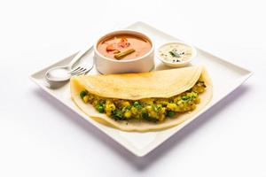 A dosa, also called dosai, dosey, or dosha, is a thin pancake in South Indian cuisine photo