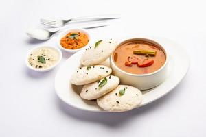 Idly sambar or Idli with Sambhar and green, red chutney. Popular South indian breakfast photo