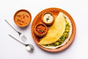 A dosa, also called dosai, dosey, or dosha, is a thin pancake in South Indian cuisine photo