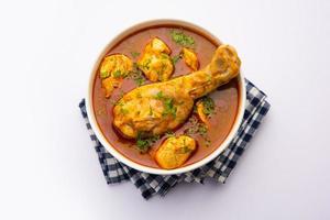 Red Chicken Curry or murgh Masala or korma with prominent Leg Piece photo