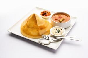 Cone shape dosa, also called dosai, dosey, or dosha, is a thin pancake in South Indian cuisine photo