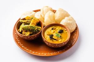 Cholar dal and patol aloo sabzi served with fried Luchi or poori, bengali food photo