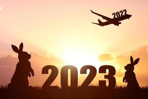 The concept of moving through 2022 to 2023. Happy New Year 2023. photo