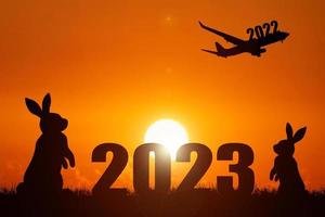 The concept of moving through 2022 to 2023. Happy New Year 2023. photo