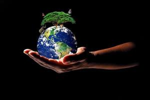 Earth on hand on black background. The concept of loving the earth, protecting the environment photo