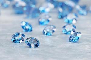 Group of Blue diamond sapphire placed on glossy background main object focus 3d rendering photo