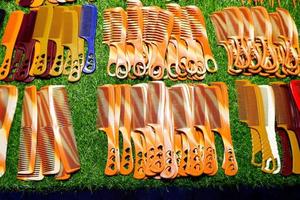 A large number of styling combs of various types are sold on the table. photo