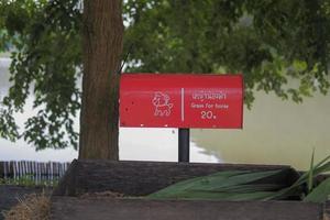 A pole with a red sign indicates that this area is for feeding the horses. photo