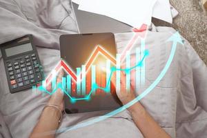 Concept stock return investment technology. business growth plan with virtual hologram chart Calculate earnings and capital gains and increase in positive growth indicators. photo