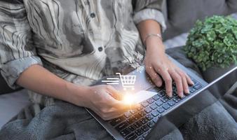 Woman using credit card filling in billing information in purchase of laptop computer in ecommerce store. Concept online payment. Internet accessible money transactions photo