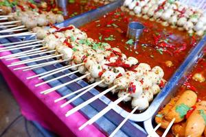 The meatballs are skewed and grilled, followed by a spicy, sour, sweet dipping sauce, a street food in Thailand. photo