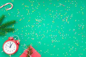 Christmas pattern flat lay with red alarm clock photo