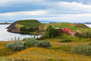 Icelandic Landscape with Cottage at Mivatn Lake Coastline photo