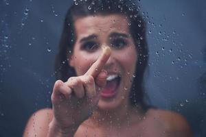 Adult woman under the shower in bathroom photo