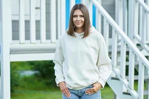 Young woman in white hoodie. photo