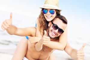 Young couple having fun at the beach photo