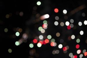 On a black background bokeh from explosions of colorful fireworks. photo