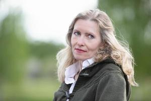 Portrait of a beautiful elderly blonde woman of European appearance. Fifty-year-old woman close-up on a natural background photo