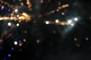 On a black background bokeh from explosions of colorful fireworks. photo