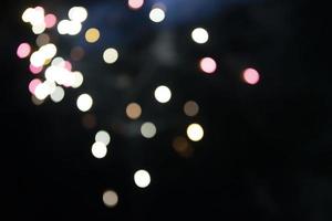On a black background bokeh from explosions of colorful fireworks. photo