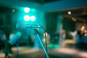 Microphone on abstract blurred of speech in seminar room or speaking conference hall light, Event Background photo
