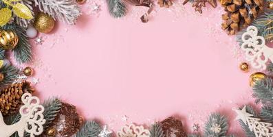 Merry Christmas or Happy Holidays blank greeting card with Xmas decoration on pink background. Noel. Flat lay photo