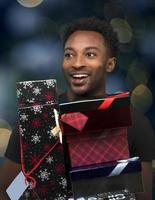 man holding christmas gifts boxes bokeh lights blue holidays background photo
