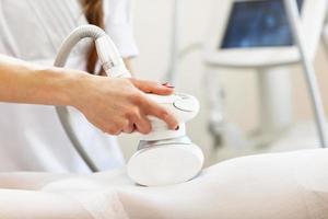 Woman having abdominal treatment in beauty salon photo